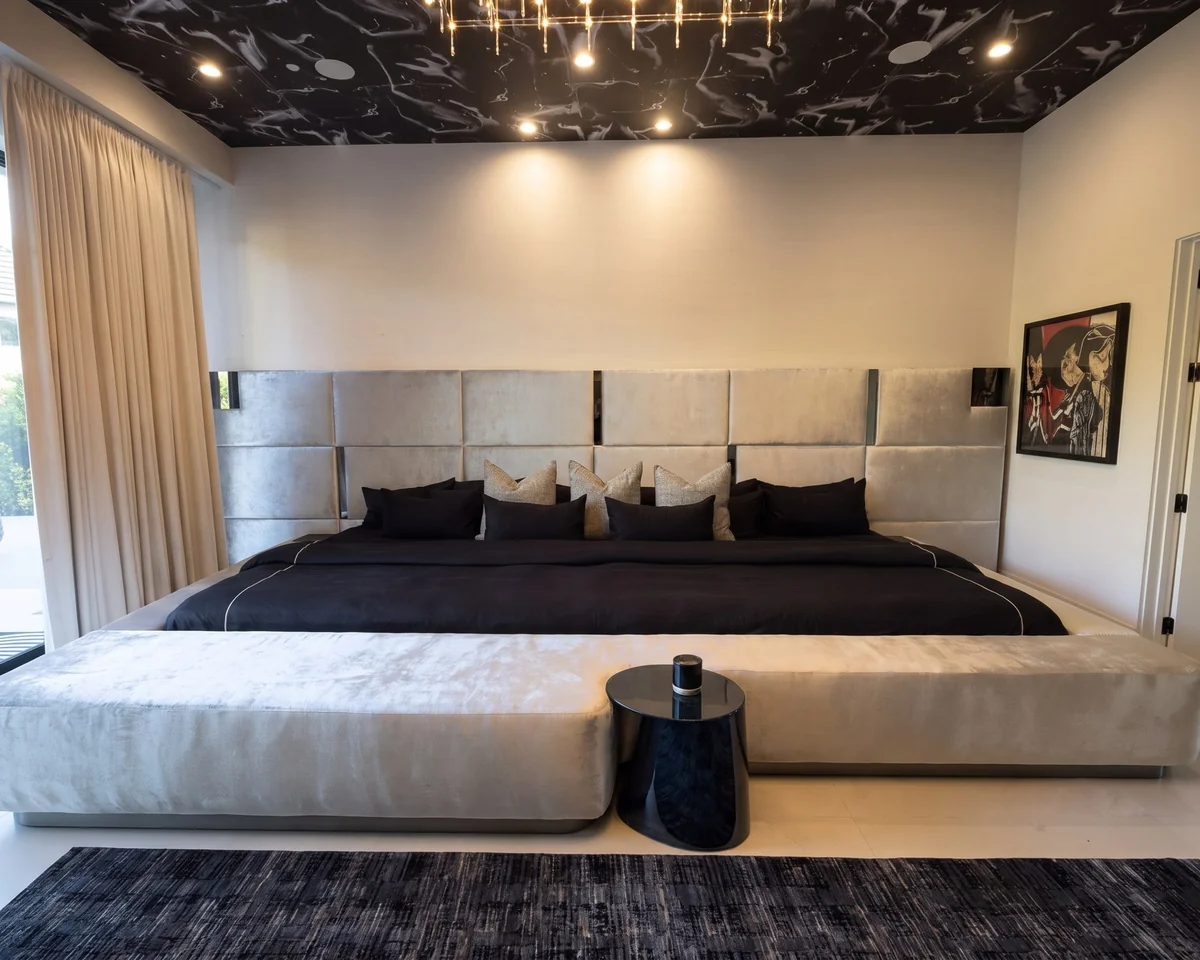 Extra-wide custom velvet bed with a long bench, built by Venegas Designs for Chris Brown