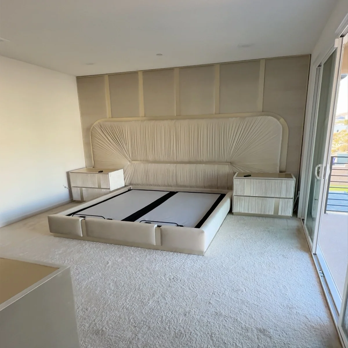 Cream upholstered bed frame with curved channel upholstery