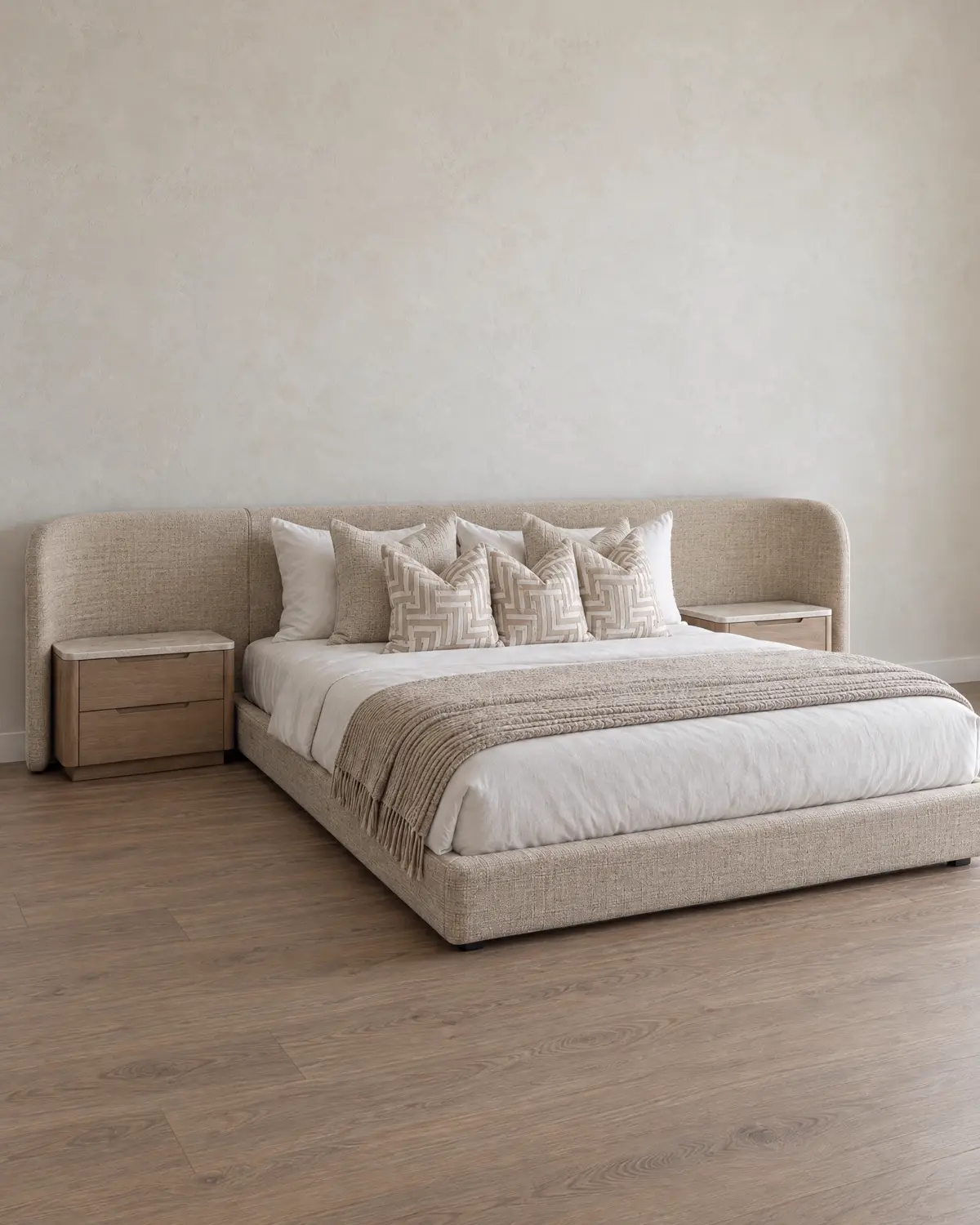 Custom cream upholstered bed frame with a curved headboard