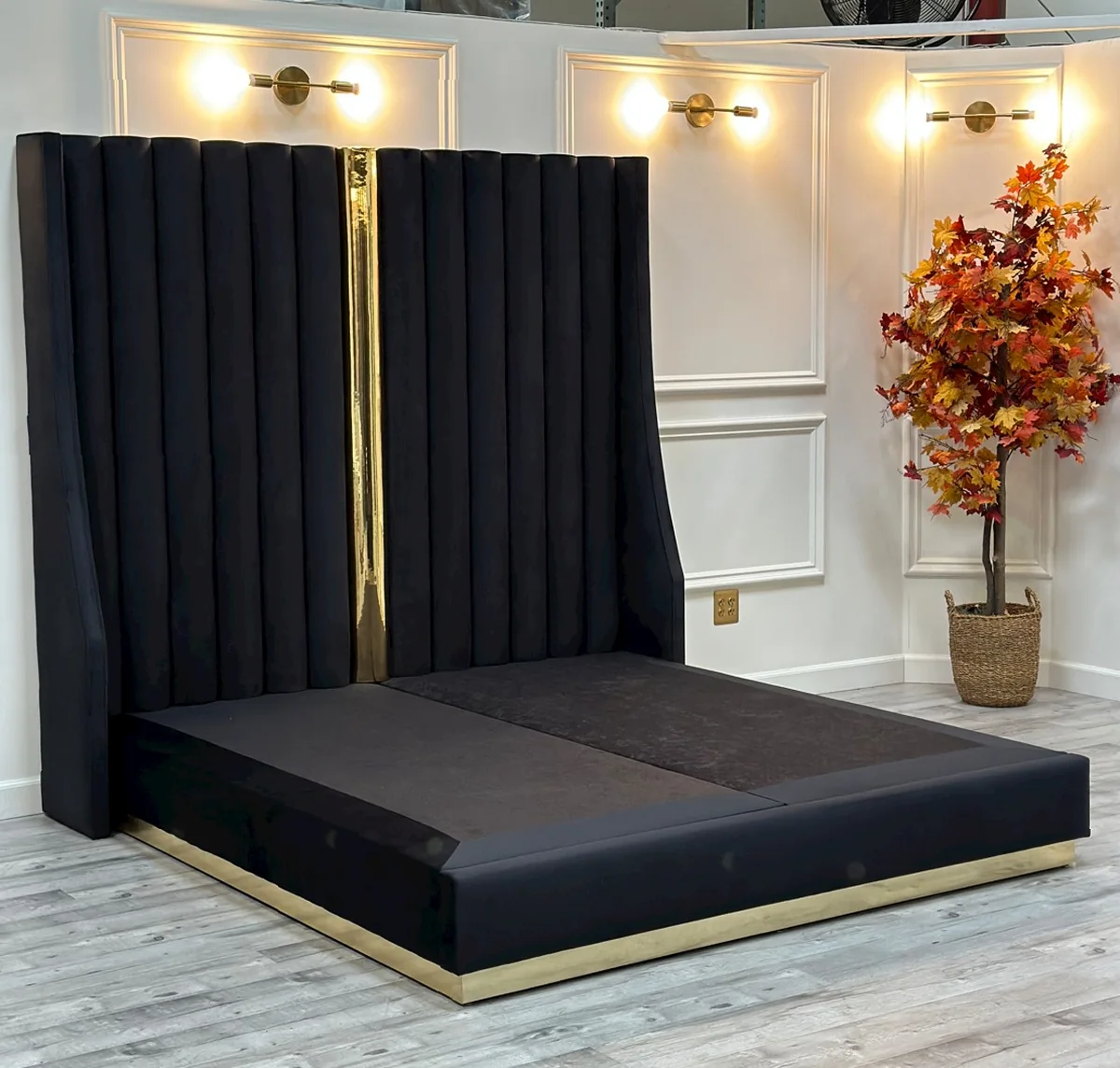 Our custom bed frame with a solid platform base and polished gold trim, before the mattress goes on